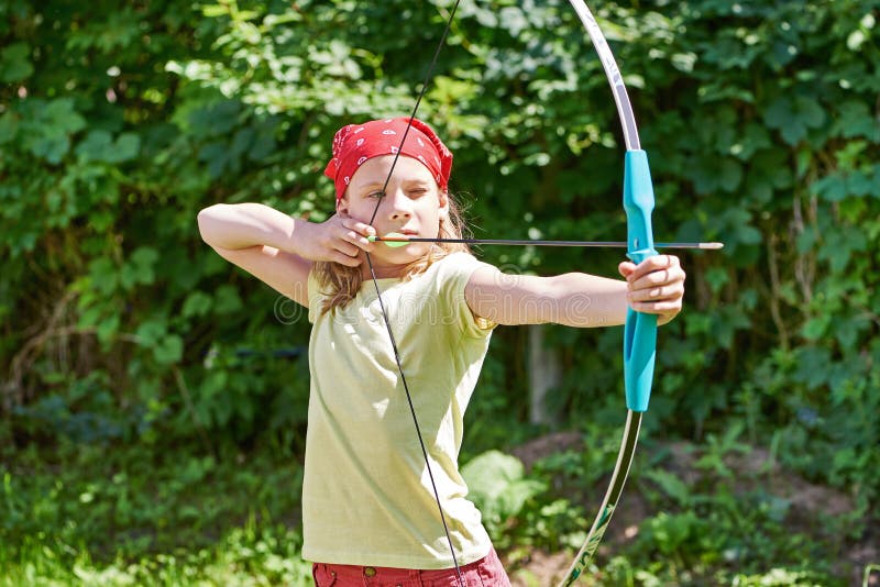 Girl with bow shooting to sport aim