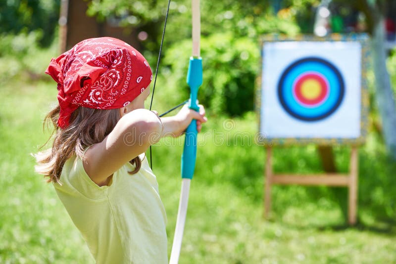 Girl with bow shooting to sport aim