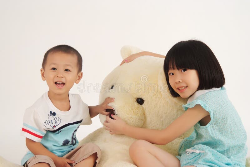 Girl and boy with bear toy