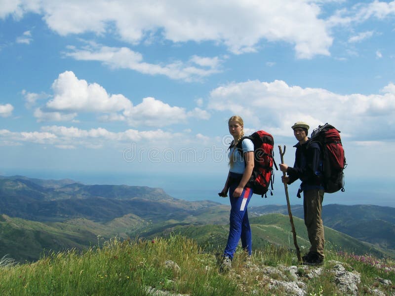 Girl and boy on green hill stock photography