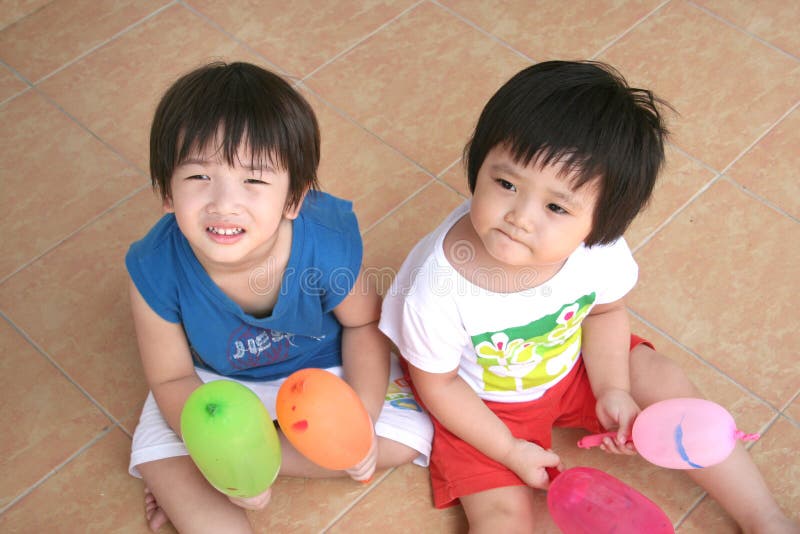 Girl & boy holding balloons