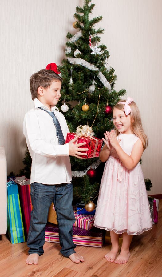 Girl and boy near a fir-tree