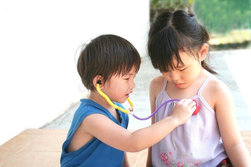 Girl & boy playing stethoscope