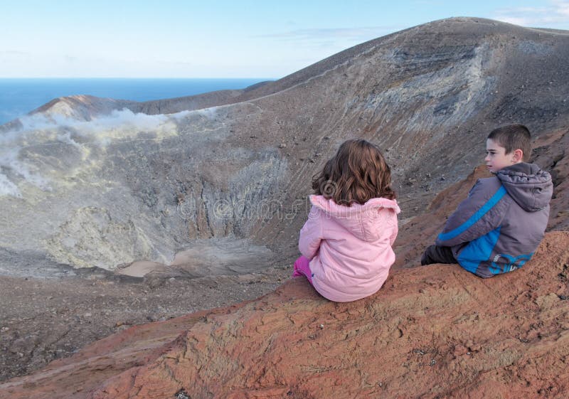 Download Girl And Boy Sitting On The Rim Of Volcano Crater Stock Image - Image of mountain, crater: 24624111