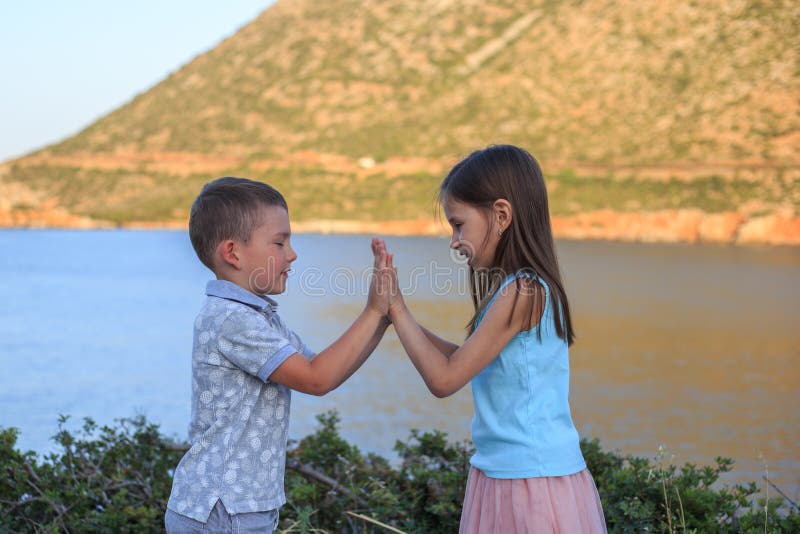 Girl and boy together outdoors. small brother playing with older sister royalty free stock photo Girl and boy together outdoors. small brother playing with older sister royalty free stock photo