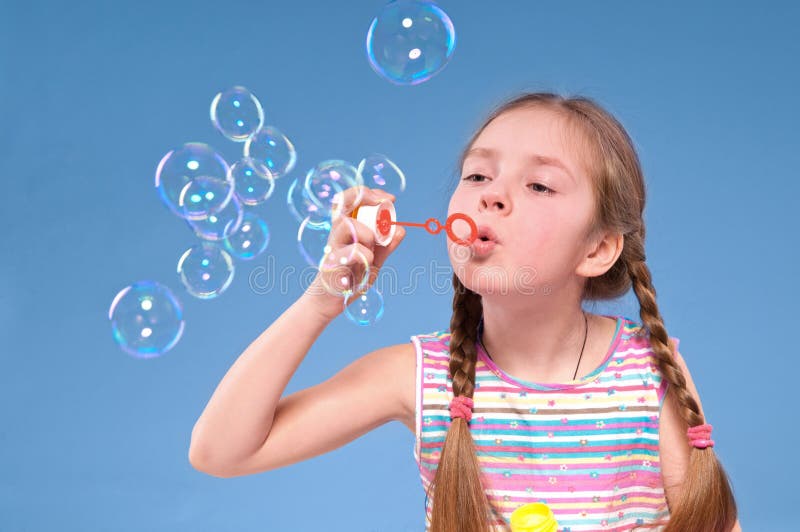 Young girl blowing bubbles stock photo. Image of energetic 14271618