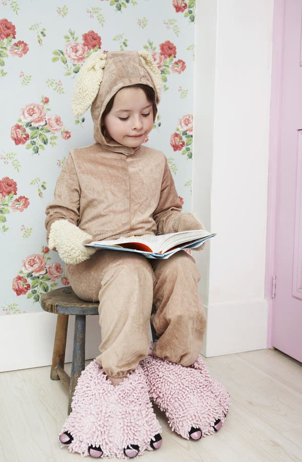 Girl In Bunny Costume And Monster Slippers Reading