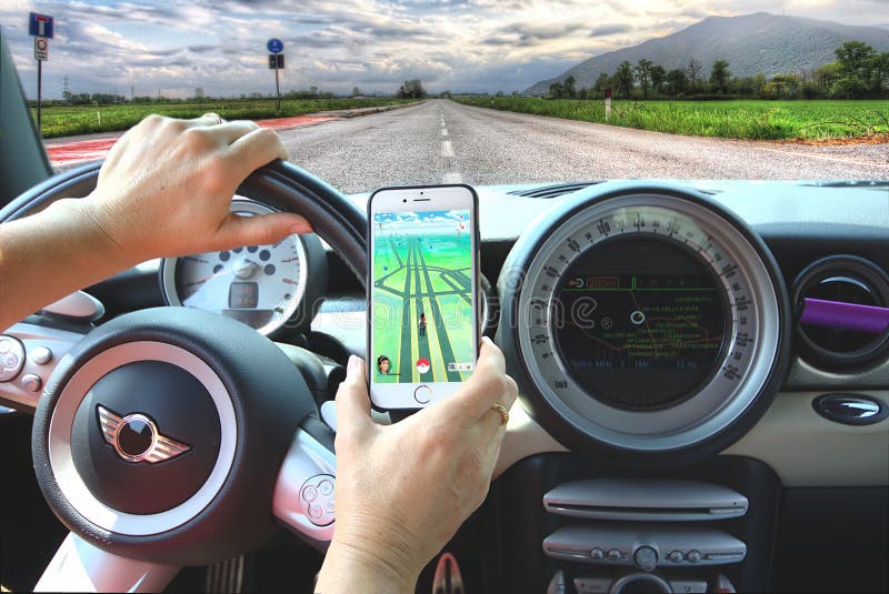 Girl caching Pokemon while driving a car.