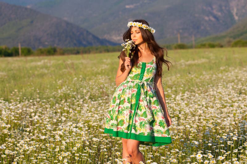 Girl on camomile field.