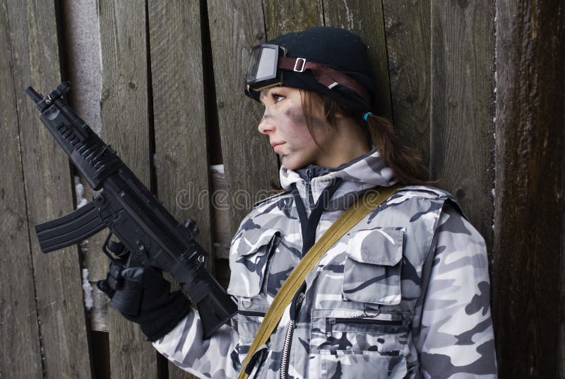 Girl in a camouflage with the gun