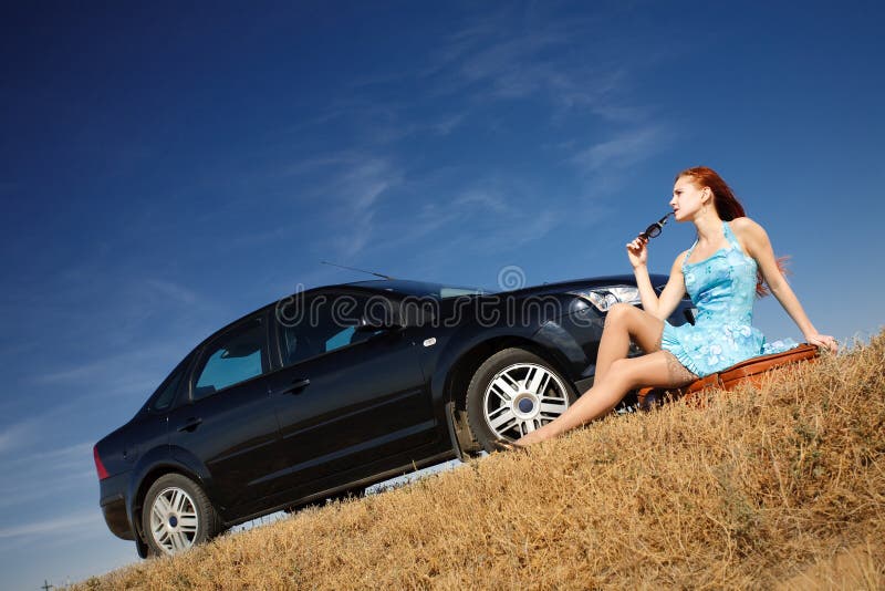 Girl by the car with sunglasses