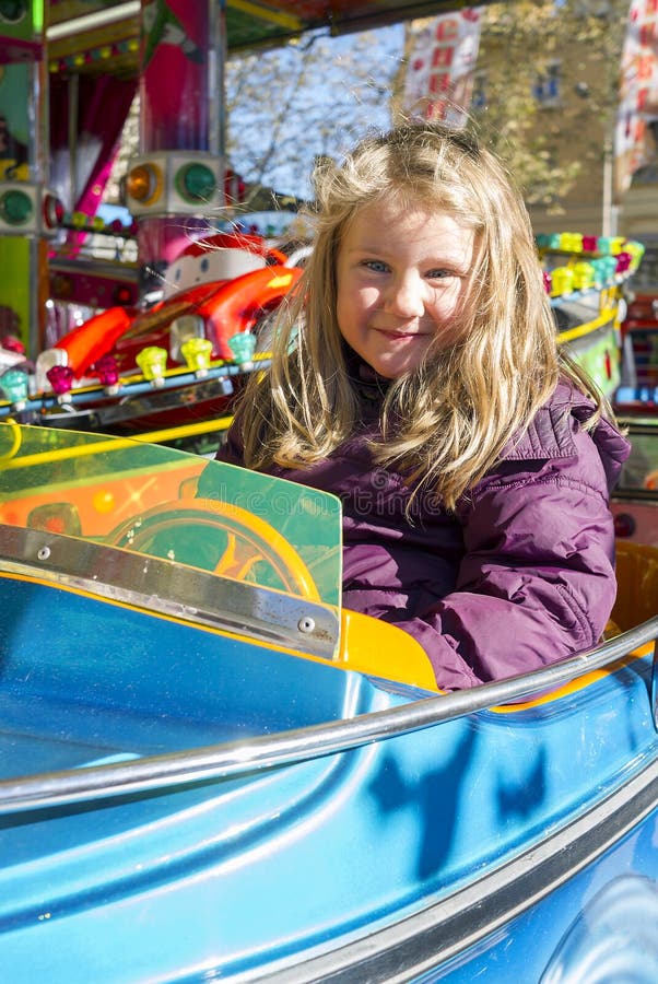 Girl on carousel stock photo