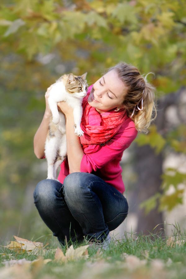 Girl with cat on natural background