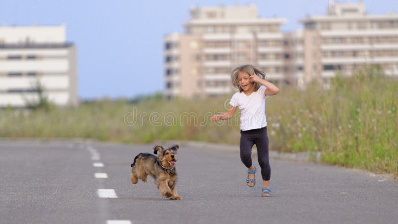 Girl chasing her puppy