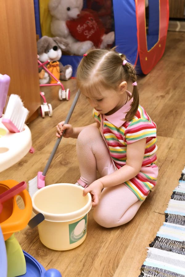 Girl cleaning her room stock image. Image of floor, serious 5177173