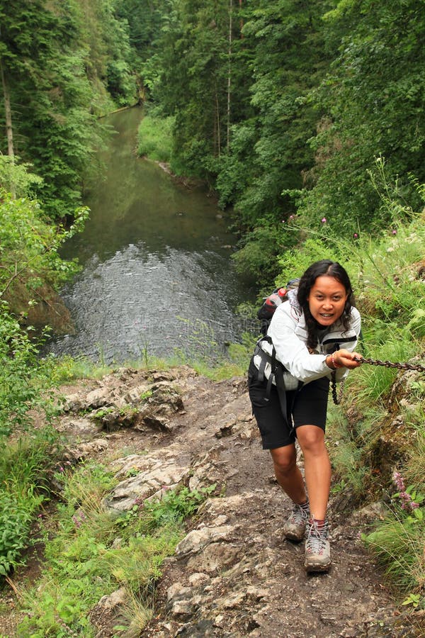 Girl climbing a rock in Slovak Paradise