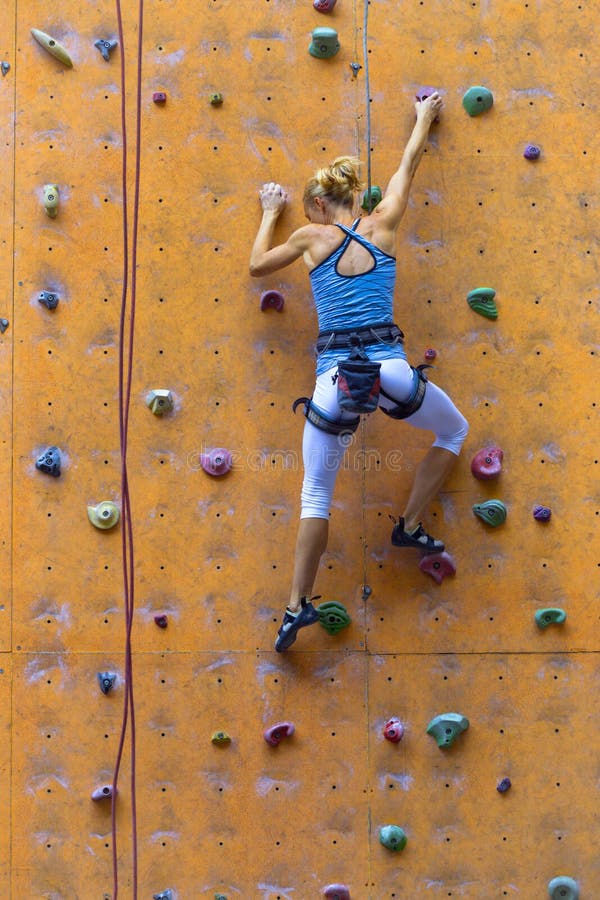 Girl climbing up the wall stock photo. Image of female 176113642