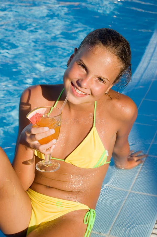 The girl with a cocktail at pool