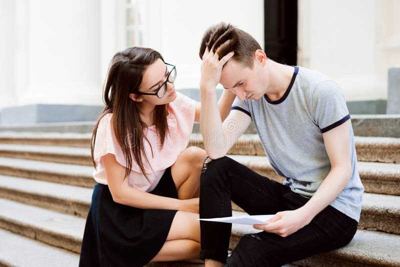 Girl Comforting Her Depressed Frustrated Friend And Gives Him Some Help