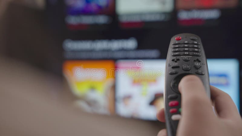 Girl Controls the TV Remote Control in Room at Home, Rest on Weekend ...