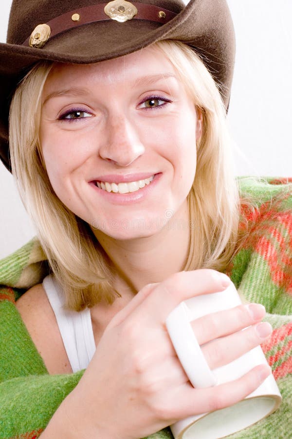 Girl in a cowboy hat with cup of tea