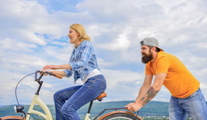 Woman rides bicycle sky background. 