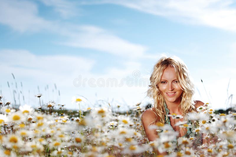 Girl on the daisy flowers field