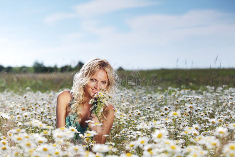 Girl on the daisy flowers field