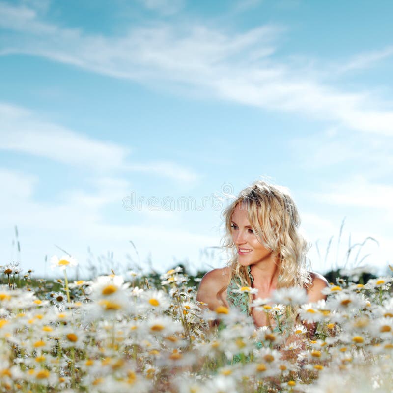 Girl on the daisy flowers field