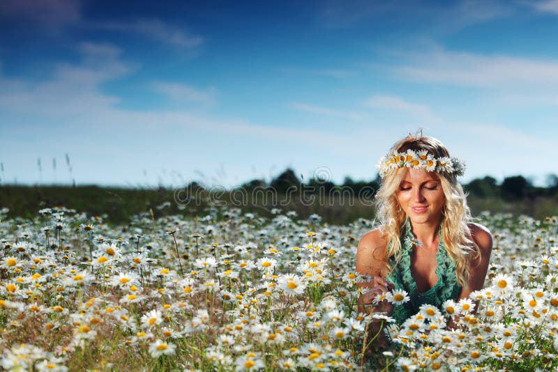 Girl on the daisy flowers field