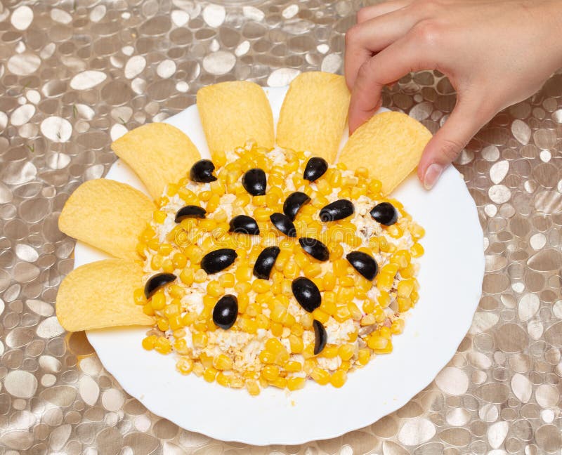 The Girl Decorates a Dish of Corn with Chips. Stock Image Image of