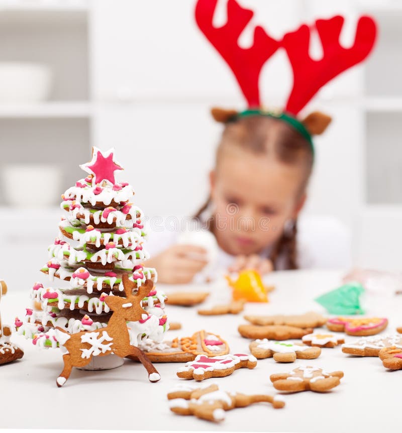 Girl decorating gingerbread cookies