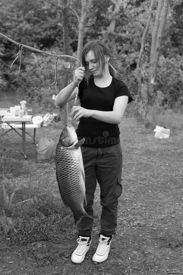 Young Woman Fishing Catching a Big Fish in Realistic 21st Century