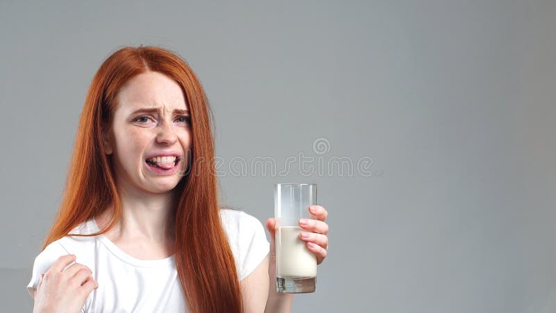 The Girl Doesn`t Like Milk And Looks Sad For A Glass Of Milk Stock