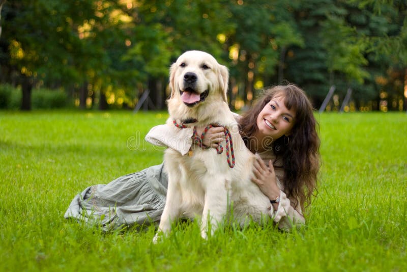 Girl with a dog on the grass