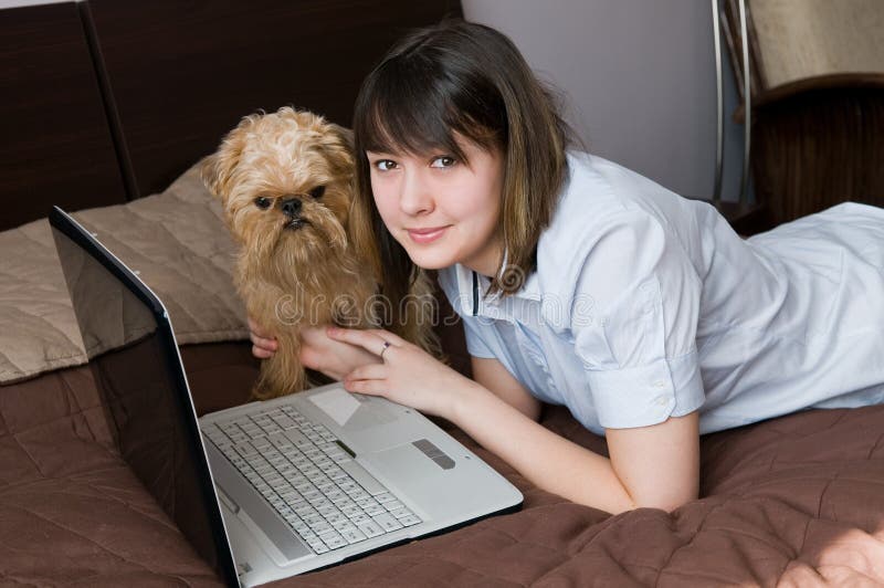 Girl with a dog and the laptop