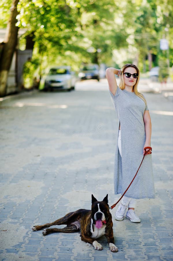 Girl with Dog Pit Bull Terrier on a Walk. Stock Photo Image of