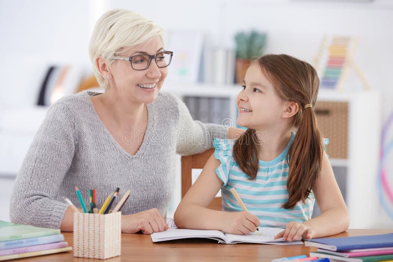 Girl doing homework with tutor