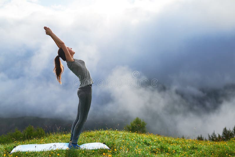Girl Doing Yoga Exercise on Lawn in Mountains Stock Photo Image of