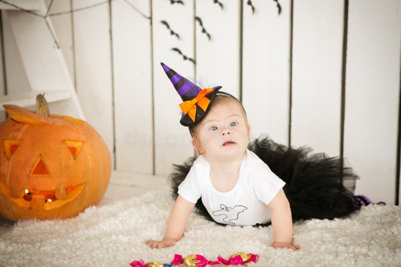 Girl with Down Syndrome Sitting Near a Big Orange Pumpkin Stock Photo ...