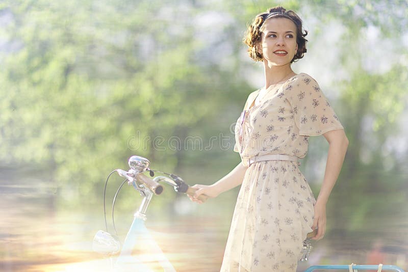 Girl in dress on bicycle stock photo. Image of fashion 63504804