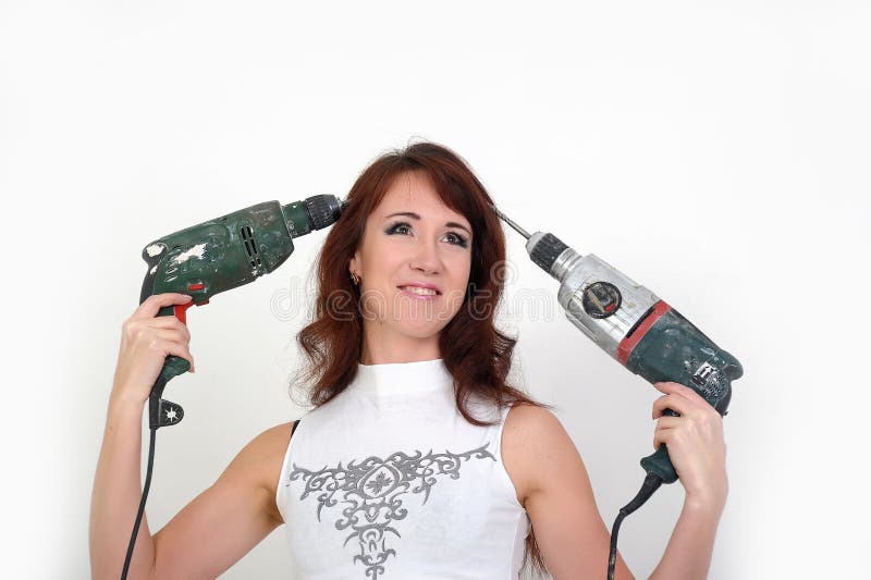 Girl with drilling machine stock photo. Image of hard 23649750