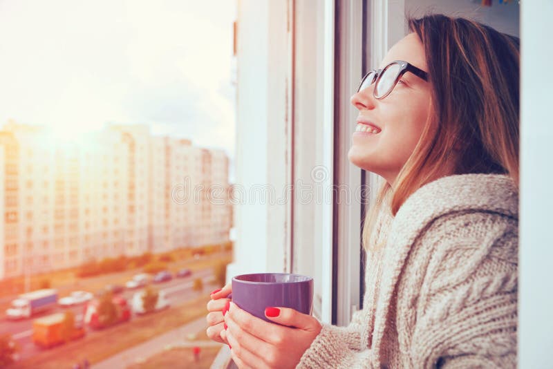 Girl drinking coffee in morning stock photography