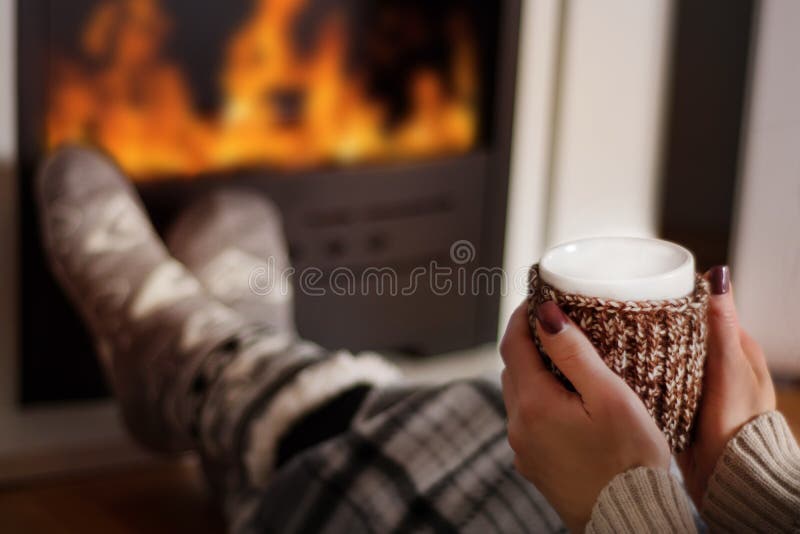 Cozy Winter Nights: Warming by the Fireplace with Hot Tea