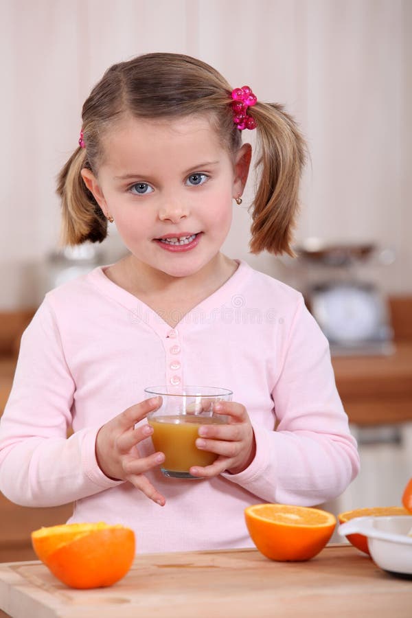 Girl drinking orange juice stock image. Image of rubber 35737285
