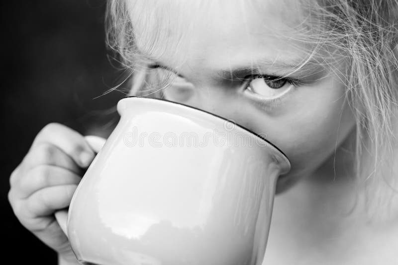 Girl drinking something. Water, Juice or Milk. Happy moments. Carefree child. stock photo Girl drinking something. Water, Juice or Milk. Happy moments. Carefree child. stock photo