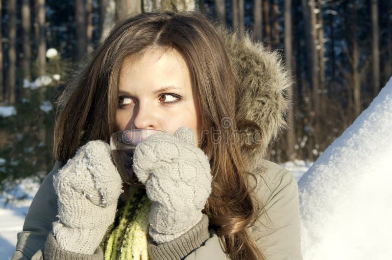 Girl drinking tea in nature