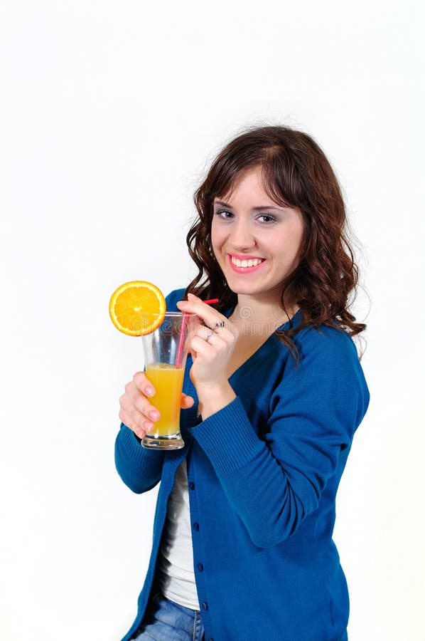 The girl drinks orange juice stock photo