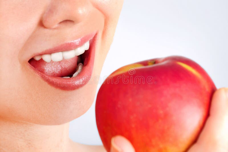 Girl eating apple stock image. Image of girl, face, grey 55912931