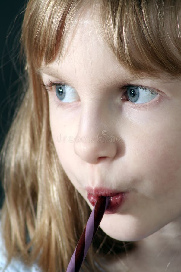 Girl eating Candy Cane stock photo. Image of christmas 3855306